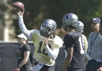  ?? Cliff Grassmick, Daily Camera ?? CU quarterbac­k Brendon Lewis passes during practice on Friday.