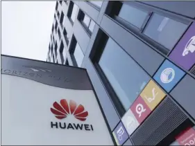  ??  ?? The Huawei logo displayed at the main office of Chinese tech giant Huawei in Warsaw, Poland, on Friday. AP PHOTO/CZAREK SOKOLOWSKI