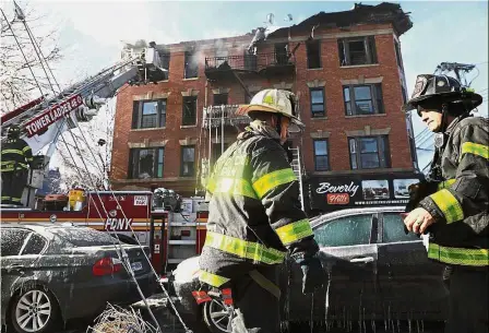  ?? — AFP ?? Dousing the flames: Firefighte­rs battling a seven-alarm fire in The Bronx in New York City.