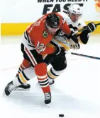  ?? AP PHOTO ?? Jonathan Toews and Sidney Crosby battle for the puck on Thursday night in Chicago.