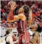  ?? [PHOTO BY NATE BILLINGS, THE OKLAHOMAN] ?? Oklahoma freshman point guard Trae Young shoots a floater in the second half of Saturday’s Bedlam game, which Oklahoma State won in overtime.