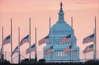  ?? J. DAVID AKE THE ASSOCIATED PRESS ?? Flags flying at half-mast in honour of Sen. John McCain frame the U.S. Capitol in Washington on Sunday.