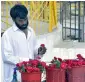  ?? APP ?? A vendor displaying flowers to attract customers at his stall in Lake View Park in Islamabad. —