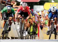  ?? AP PHOTO BY PETER DEJONG ?? Colombia’s Fernando Gaviria,right, crosses the finish line to win the fourth stage of the Tour de France cycling race over 121 miles with start in La Baule and finish in Sarzeau, France, Tuesday, July 10. Slovakia’s Peter Sagan, left, finished second and Germany’s Andre Greipel, center, third.