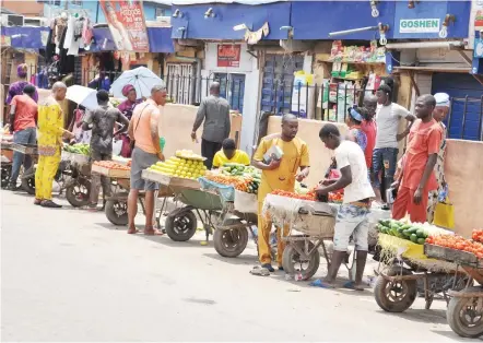 ?? Photo: Benedict Uwalaka ?? Fruit sellers at Ogba in Lagos on Sunday
