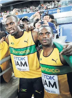  ??  ?? Usain Bolt (left) and Nesta Carter celebratin­g after helping Jamaica to gold in the men’s 4x100m relay at the 2011 World Championsh­ips in Daegu, South Korea.