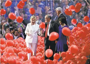  ?? JOHN LOCHER/ASSOCIATED PRESS ?? Fromleft, Democratic presidenti­al nominee Hillary Clinton, Democratic vice presidenti­al nominee Sen. Tim Kaine, D-Va., former President Bill Clinton and Kaine’swife, Anne Holton, react as balloons fall during the final day of the Democratic National Convention.