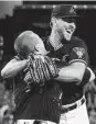  ?? Matt York / Associated Press ?? Tyler Gilbert celebrates with catcher Daulton Varsho after his feat.