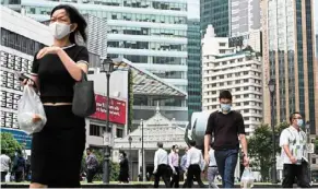  ?? ?? On the move: People walking around raffles Place in January 2020. ‘Whenever we can open, we will open up further,’ says ong. — AFP