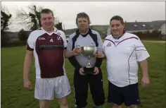  ??  ?? Team captains, Tony Donoghue (Coolboy) and John Rawson (Coolafancy) with referee Christy O’Rourke.