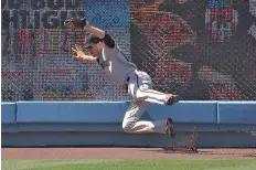  ?? AP Photo/Mark J. Terrill ?? ■ San Francisco Giants left fielder Austin Slater makes a catch on a ball hit by Los Angeles Dodgers’ Corey Seager during the sixth inning of a baseball game Saturday in Los Angeles.