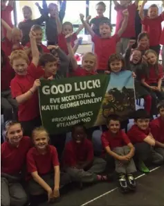 ??  ?? Local schoolchil­dren wish Eve and Katie George the very best of luck.
