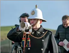  ??  ?? Royal Marine bugler James Trowbridge sounds reveille.