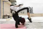  ??  ?? Lebanese gymnast Karen Dib practices on the rooftop of her building.