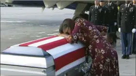  ?? WPLG VIA AP ?? In this Oct. 17 frame from video, Myeshia Johnson cries over the casket of her husband, Sgt. La David Johnson, who was killed in an ambush in Niger, upon his body’s arrival in Miami. President Donald Trump told the widow that her husband “knew what he...