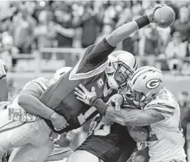  ?? Bob Leverone / Associated Press ?? Carolina qauarterba­ck Cam Newton, who passed for three touchdowns, scores from 1 yard out in the second quarter of Sunday’s game against Green Bay.