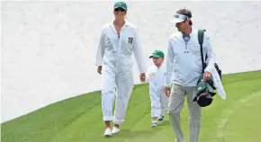  ?? MADRID / USA TODAY SPORTS ?? Bubba Watson walks with wife Angie and son Caleb during the Par 3 Contest before the 2016 Masters tournament at Augusta National Golf Club.