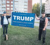  ?? ALESSANDRO RAMPAZZO/AFP/GETTY IMAGES ?? Supporters of U.S. President Donald Trump hold a banner to welcome him in Helsinki, Finland, on Sunday. .