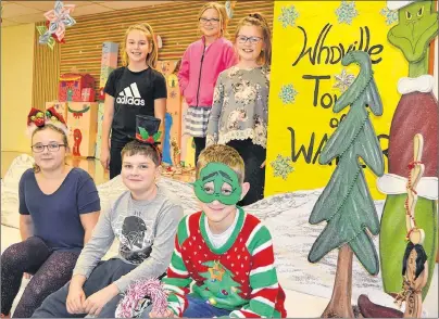  ?? ERIC MCCARTHY/JOURNAL PIONEER ?? Taking a break near the Whoville Tower of Water are seated from left, Abby Bridges as Martha Mae, Reid Yeo as Mayor MayWho, Titus Raynor as the Grinch and from back left are Maggie Biggar, a Who; Tessa Smith as Cindy Lou Who and Ava Perry as a Who....