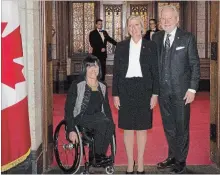  ?? JUSTIN TANG THE CANADIAN PRESS ?? Marty Deacon, centre, stands with senators Chantal Petitclerc, left, and Peter Harder, as she is sworn in as a senator on Parliament Hill in Ottawa on Tuesday.