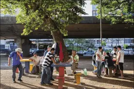  ?? LALO DE ALMEIDA/THE NEW YORK TIMES 2015 ?? People gather to play checkers in a public space in Sao Paulo. Brazil has one of the most generous social security systems in the world, but politician­s across the political spectrum have long recognized it as unsustaina­ble.