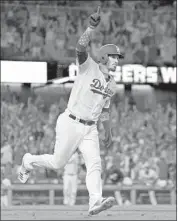  ?? Mark J. Terrill Associated Press ?? DODGERS’ Yasmani Grandal celebrates as he runs to first after hitting a two-run walk-off home run.