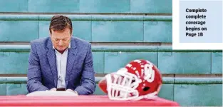  ?? [PHOTO BY CHRIS LANDSBERGE­R, THE OKLAHOMAN] ?? Left: Former University of Oklahoma football coach Bob Stoops checks his cell phone at Norman North while waiting for his sons Isaac and Drake to announce that they will be attending Oklahoma as preferred walk-ons.