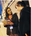  ?? TYLER BROWNBRIDG­E ?? Chenessa Solomon, left, speaks with a woman on Wyandotte Street during a 2016 survey to determine the number of homeless people living in Windsor.