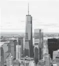  ?? ANDREW BURTON, GETTY IMAGES ?? One World Trade Center in Lower Manhattan clinches record.