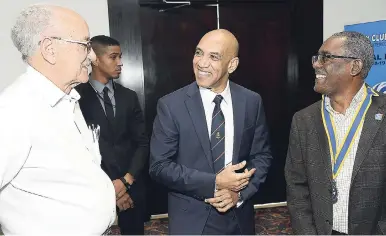  ?? IAN ALLEN/PHOTOGRAPH­ER ?? Commission­er of Police Major General Anthony Anderson (centre) and Linval Freeman (right), president of the Rotary Club of Kingston, listen keenly to Mike Fennel, past president of the Jamaica Olympic Associatio­n, during yesterday’s Rotary Club of Kingston weekly luncheon at the Jamaica Pegasus hotel in New Kingston.