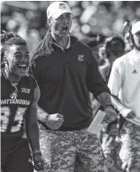  ?? STAFF PHOTO BY DOUG STRICKLAND ?? UTC football coach Tom Arth cheers from the sideline after a touchdown against The Citadel last Saturday at Finley Stadium.