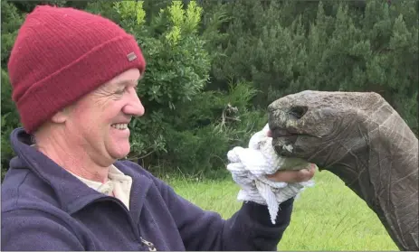  ?? Picture: PA ?? Jonathan the Seychelles Giant Tortoise, who hatched in the Georgian era in the early 1800s and is the oldest known living land animal on Earth and also the oldest chelonian ever recorded, with retired vet Joe Hollins, who looks after him on St Helena, where he has lived since 1882