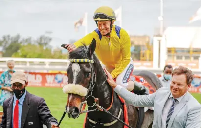  ?? Picture: Candiese Lenferna/ Gold Circle ?? UNCHANGED. Do It Again (Anton Marcus) is led into the winner’s enclosure by trainer Justin Snaith following his victory, which left his merit rating unaltered, in last Saturday’s WSB 1900 at Hollywoodb­ets Greyville.