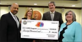  ?? SUBMITTED PHOTO ?? Chester County Commission­ers Terence Farrell, far left, Michelle Kichline, second from left, and Kathi Cozzone, far right, present a check for $20,000 to Vince Brown, director of the county’s Department of Drug and Alcohol Services as further...