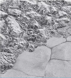  ?? —AFP ?? This highest-resolution file image from NASA’s New Horizons spacecraft taken December 4, 2015 and obtained June 1, 2018, shows great blocks of Pluto’s water-ice crust appearing jammed together in the informally named al-Idrisi mountains, some mountain...