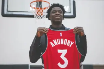  ?? CP PHOTO ?? Toronto Raptors 2017 first round draft pick OG Anunoby holds a jersey as he poses for a picture after scrumming with journalist­s during a media availabili­ty in Toronto on Friday.