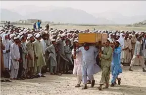  ?? EPA PIC ?? People attending the funeral of victims who were killed in a suicide bomb attack, in Rodat district, Afghanista­n, yesterday.