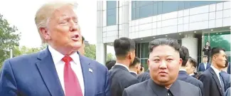  ?? Yonhap ?? North Korean leader Kim Jong-un right, listens as U.S. President Donald Trump speaks during a surprise meeting in Panmunjeom in the inter-Korean border area, June 30.