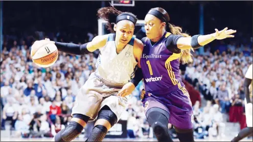  ??  ?? In this Oct 4, 2017 file photo, Minnesota Lynx’s Maya Moore (left), drives around Los Angeles Sparks’ Odyssey Sims in the first half during Game 5 of the WNBA Finals in
Minneapoli­s. (AP)