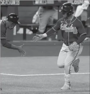  ?? TOM PENNINGTON/GETTY ?? Ozzie Albies rounds the bases after hitting a home run in the ninth inning of the Braves’ victory Tuesday.