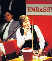  ??  ?? Taking aim: Alex Higgins at the World Championsh­ip in 1988 (left), and (above) relaxing with a cigarette between shots at the Crucible in 1983