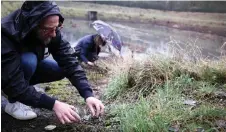  ?? — AFP photos ?? A man from Surfrider Foundation collects plastic pellets on the ground close to an industrial zone with petrochemi­cal factories in Ecaussinne­s, Belgium.