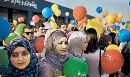  ?? BRAM JANSSEN/AP ?? Kurdish women hold balloons to protest the flight ban issued by the Iraqi government.