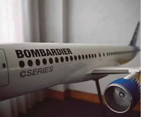  ?? REUTERS PIC ?? A model of Bombardier C Series airplane. The company employs 8,000 people in Northern Ireland, including 4,200 in aeronautic­s.