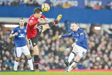  ?? — AFP photo ?? Everton’s English striker Wayne Rooney (R) shot is blocked by Manchester United’s Spanish midfielder Ander Herrera during the English Premier League football match between Everton and Manchester United at Goodison Park in Liverpool, north west England...