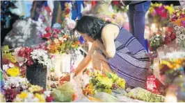  ?? STEPHEN M. DOWELL/STAFF PHOTOGRAPH­ER ?? Mourners light candles Monday night at Pulse nightclub in Orlando in honor of the 49 lives lost a year ago in mass shooting at the club.