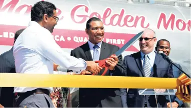  ?? Ian Allen/Photograph­er ?? Prime Minister Andrew Holness is assisted by Seprod CEO Richard Pandohie (left) and Chairman Paul B. Scott at the official opening of the new Jamaica Grain & Cereals factory on Thursday, March 15.