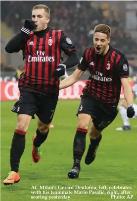  ??  ?? AC Milan's Gerard Deulofeu, left, celebrates with his teammate Mario Pasalic, right, after scoring yesterday Photo: AP