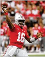  ?? DAVID JABLONSKI / STAFF ?? Ohio State’s J.T. Barrett completed 25 of 33 passes for 270 yards against Army. He threw two touchdown passes and ran for another score.