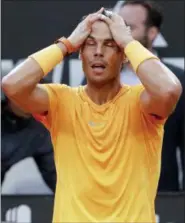  ?? GREGORIO BORGIA — THE ASSOCIATED PRESS ?? Spain’s Rafael Nadal holds his head after beating Germany’s Alexander Zverev in their final match at the Italian Open tennis tournament, in Rome, Sunday. Nadal won 6-1, 1-6, 6-3.